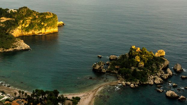 Aerial view of island and Isola Bella beach and blue ocean water in Taormina, Sicily, Italy