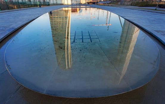 Reflections in a water  of "city life" towers in Milan, Italy.