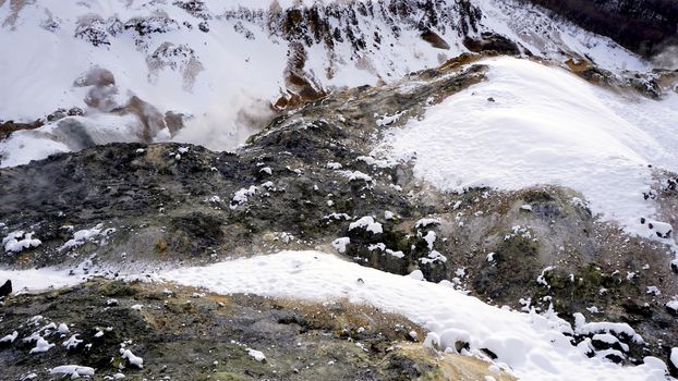 Closeup stone in the mist Noboribetsu onsen snow winter national park in Jigokudani, Hokkaido, Japan