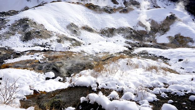 Closeup stone in the mist Noboribetsu onsen snow winter national park in Jigokudani, Hokkaido, Japan