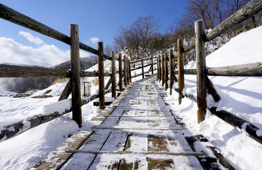 Noboribetsu onsen and walkway bridge hell valley snow winter national park in Jigokudani, Hokkaido, Japan
