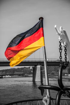 Blowing german Flag at the rear of a ship on the river elbe