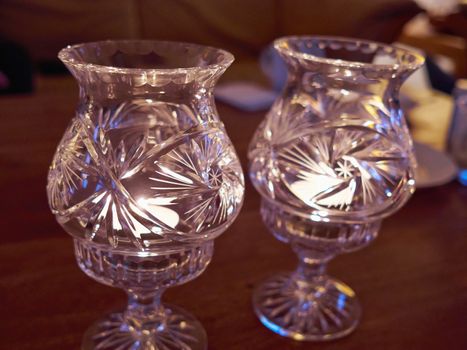 Beautiful traditional design classical glass candle holders burning candles inside     