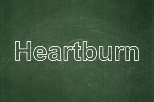 Healthcare concept: text Heartburn on Green chalkboard background