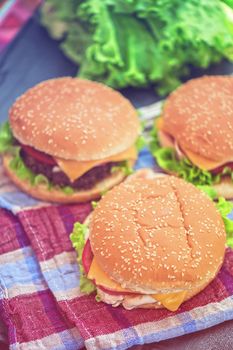 Closeup of home made burgers on wooden table