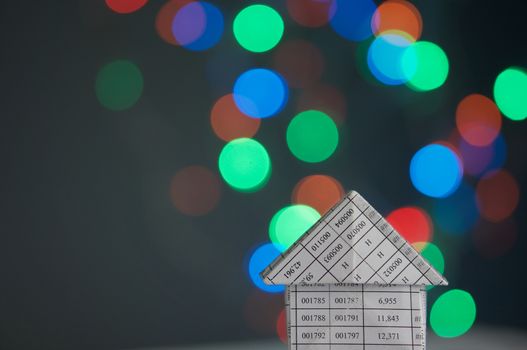 House has colorful bokeh circle or defocused of glitter at night as background.