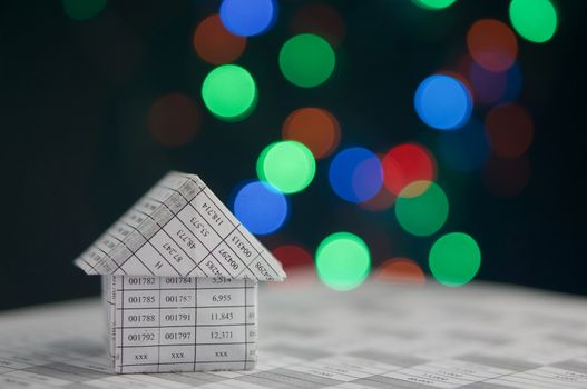 House on finance account has colorful bokeh circle or defocused of glitter at night as background.