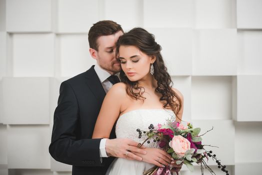 Bride and groom with bridal bouquet ready for wedding