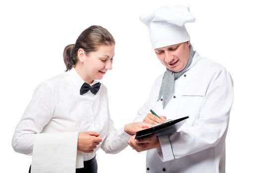 chef writes something in a notebook on a white background