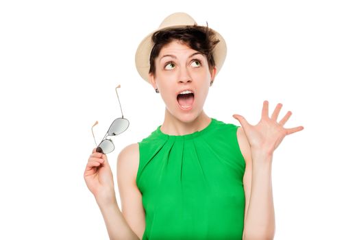 shocked emotional woman portrait on a white background with a hat