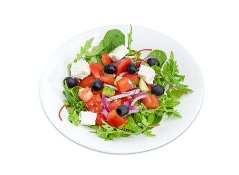 Greek salad in a white dish on a white background
