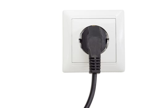 White socket outlet European standard with connected corresponding black AC power plug closeup on a light background
