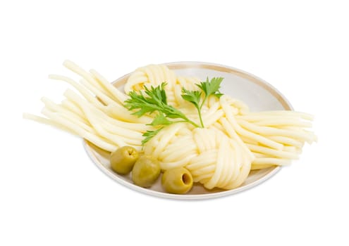 Two portions of the mozzarella cheese in the form of strings, twisted in a shape of a plait, several green olives and twig of parsley on the saucer on a light background
