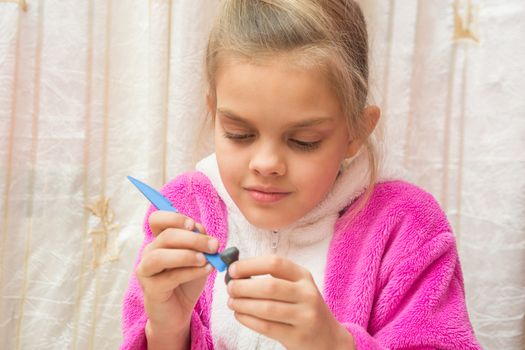 Seven-year girl sculpts from clay crafts, hand-made article makes drawing on the stack