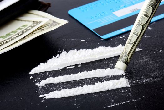 Sceen of drug use, lines of cocaine with credit card and money