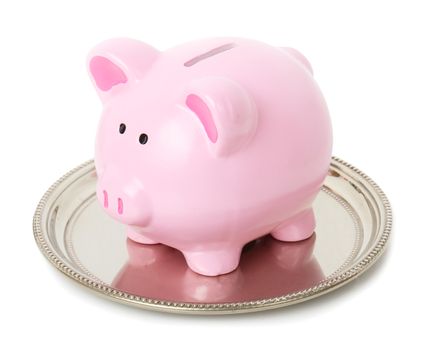 Piggy bank sat on a sliver tray isolate don a white background