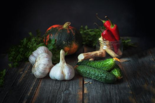 Different vegetables against a dark background in style a rustic