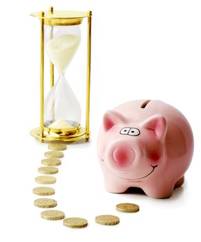 Concept of time and money with a piggybank and houreglass isolated on a white background