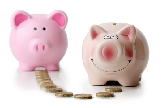 two piggy banks with money transfer concept isolated on a white background