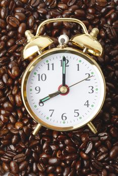 a clock on a bed of coffee beans