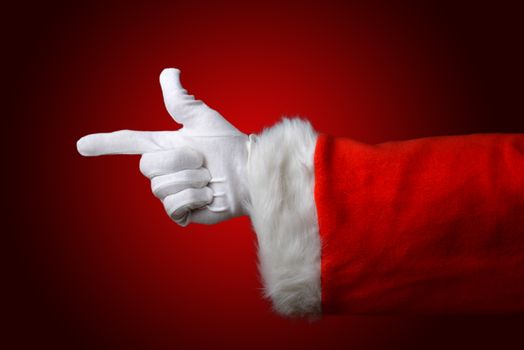 Santa Claus pointing, hand and arm only  over a light to dark red background