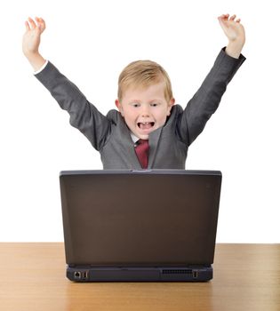 Young businessman with arms raised in success looking at a laptop isolated on a white background