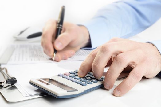 businessman with calculator  and pen focus on foreground