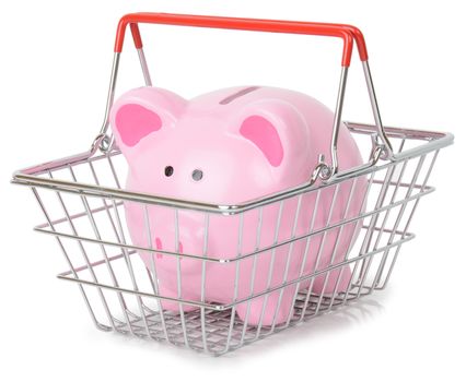 Piggy bank in a shopping basket isolated on a white background