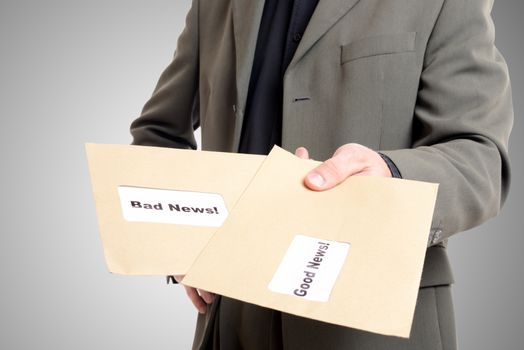 man in suit showing two envelopes one with good news and one with bad