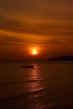 Longtail boats in sea on beautiful sunset sky background, Thailand