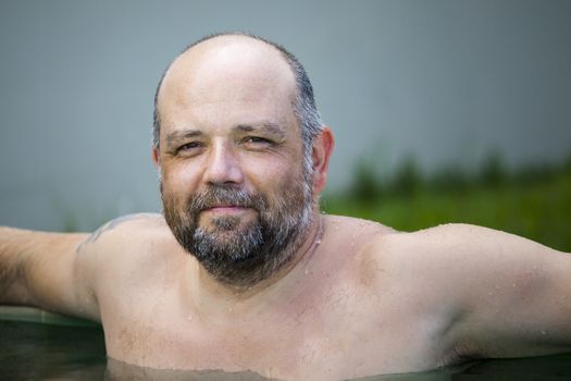 An image of a man relaxing in the pool