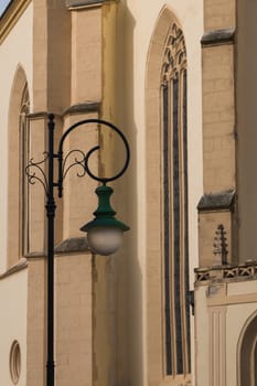 Lines of the facade of a gothic St. Jacob church in city Boskovice, Czech republic. Stylish street lamp in the foreground.