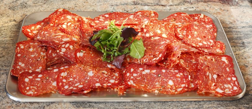 Salami and Salad on a metal plate