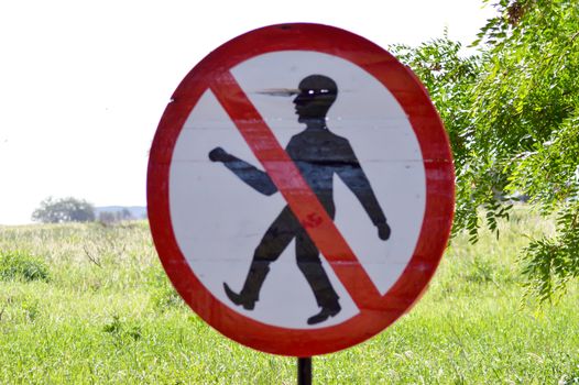 Prohibition sign to walk in the savanna of West Tsavo Park in Kenya