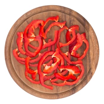 Sliced bell pepper on old cutting board. Isolated on white background. Top view. 