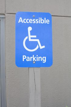 Close up of a blue accessible handicap parking sign