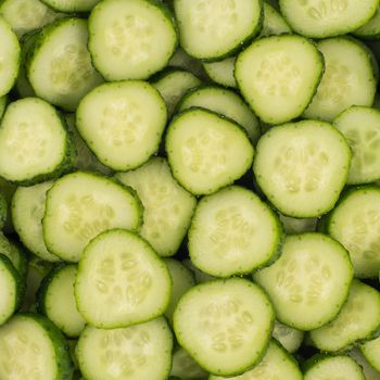 Fresh Cucumber and slices white background. Top view.