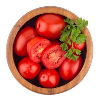 fresh tomatoes in wood bowl on white background. Top view.