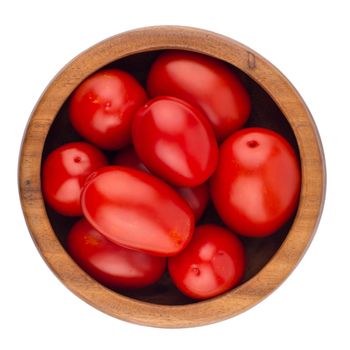 fresh tomatoes in wood bowl on white background. Top view.