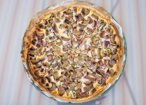 delicious rhubarb tart with sugar in a glass bowl on a table