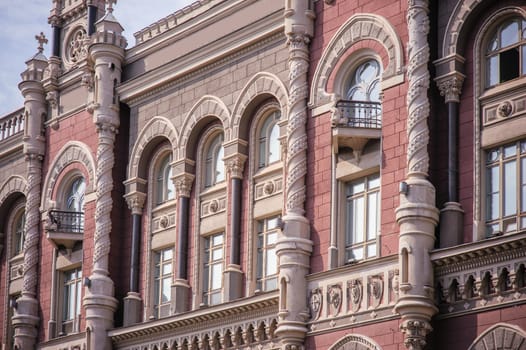 ancient architectural high rise building with windows and pillars.