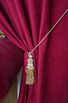 beautiful red curtain with tassel in theater.