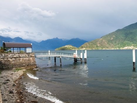 Italy, Pianello del Lario - September 05, 2015:
Pier docking with thunderstorm approaching in the background with the Piona peninsula.