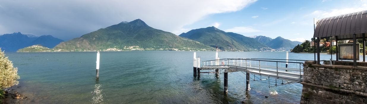 Italy, Pianello del Lario - September 05, 2015:
Pier docking with thunderstorm approaching in the background with the Piona peninsula.