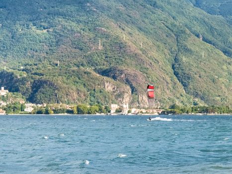 Cremia, Italy - September 5, 2015: Several windsurfing and kitesurfing with thermal wind from the south on Lake Como.