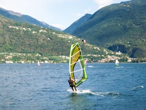 Cremia, Italy - September 5, 2015: Several windsurfing and kitesurfing with thermal wind from the south on Lake Como.