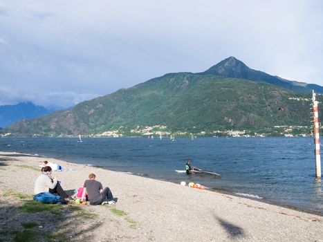 Cremia, Italy - September 5, 2015: Several windsurfing and kitesurfing with thermal wind from the south on Lake Como.