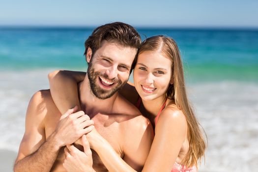 Portrait of romantic couple embracing each other on beach