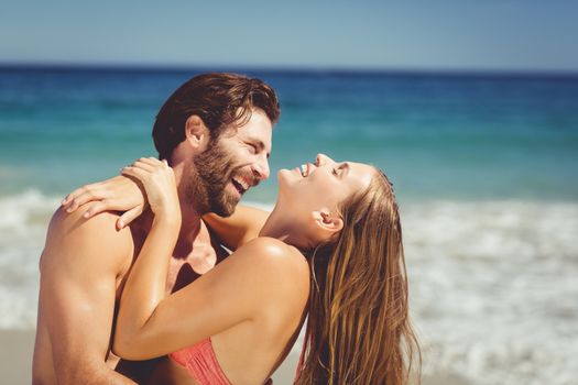 Romantic young couple having fun on beach