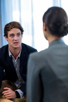 Businessman interacting with a businesswoman in office